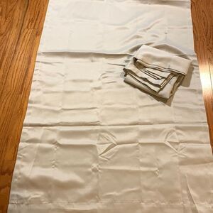 One pair of room darkening tan colors 30" x 63 Curtains.